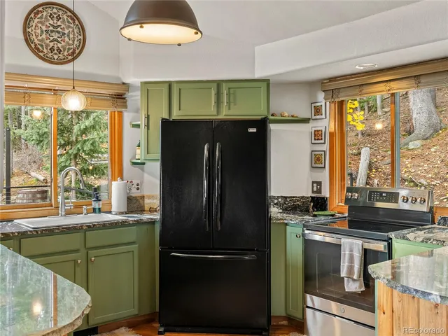 a kitchen with a refrigerator and a stove