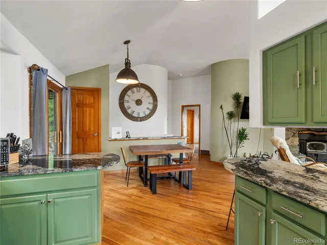 a living room with furniture and a clock