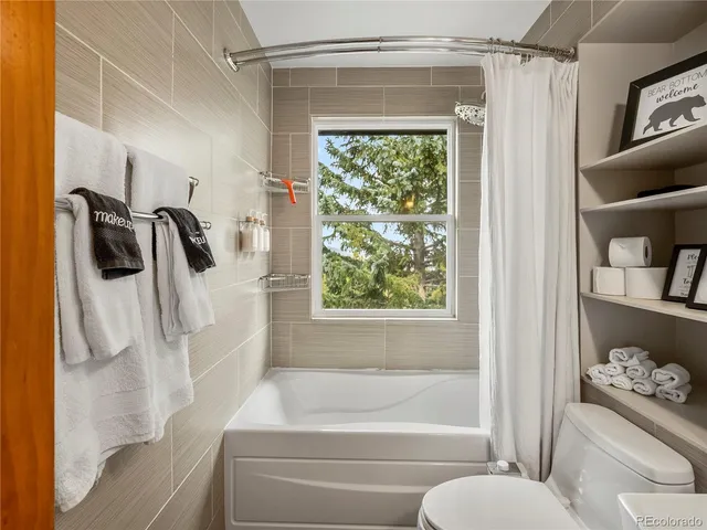 a bathroom with a shower curtain and a tub