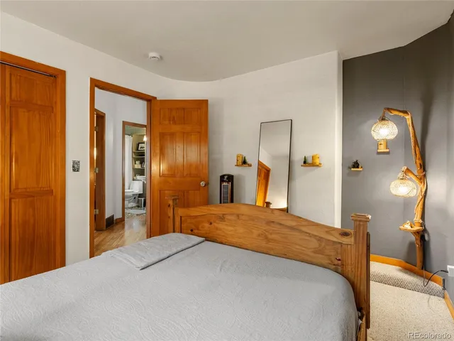 a bedroom with a bed and a lamp