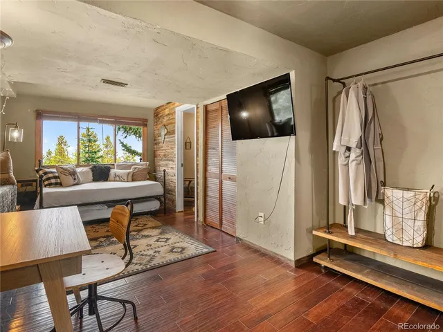 a living room with furniture and a floor to ceiling window