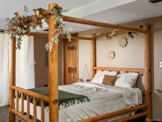 a bedroom with a bed and a mirror