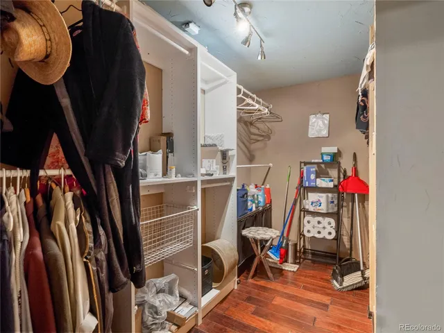 a view of walk in closet with clothes and shoes