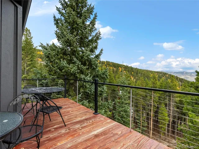 a view of a balcony with wooden floor and seating space