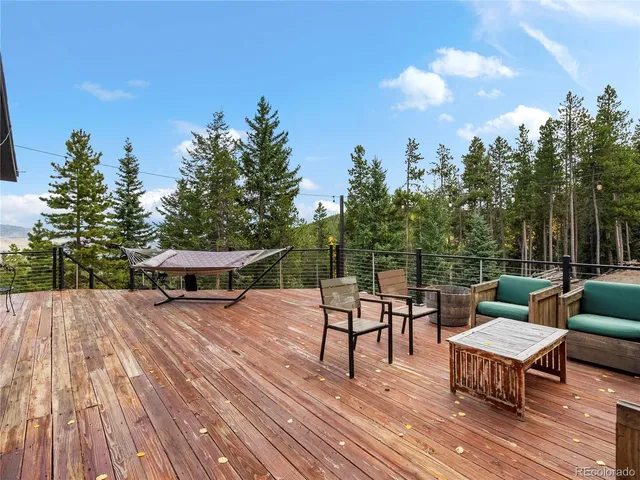 a swimming pool with outdoor seating and wooden floor