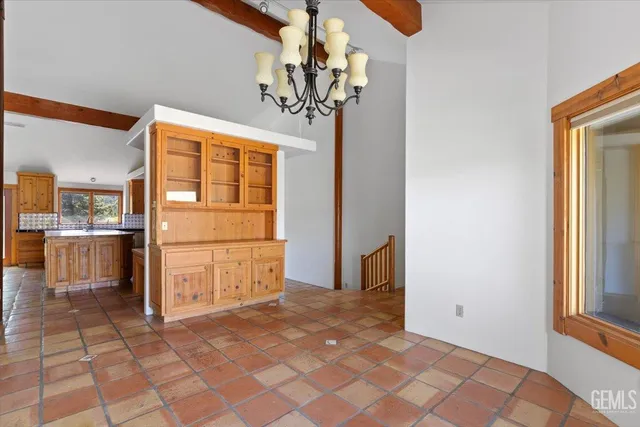 a view of a hallway with entryway and stairs
