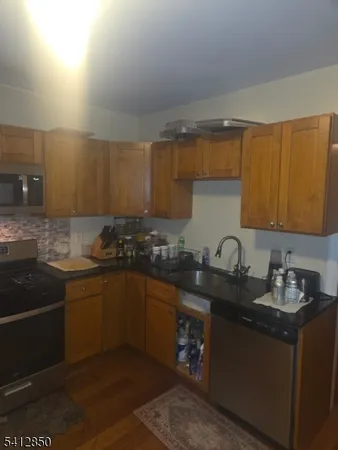 a kitchen with sink a stove and cabinets