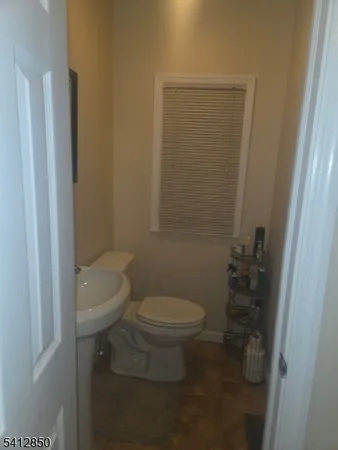 a white toilet sitting next to a shower
