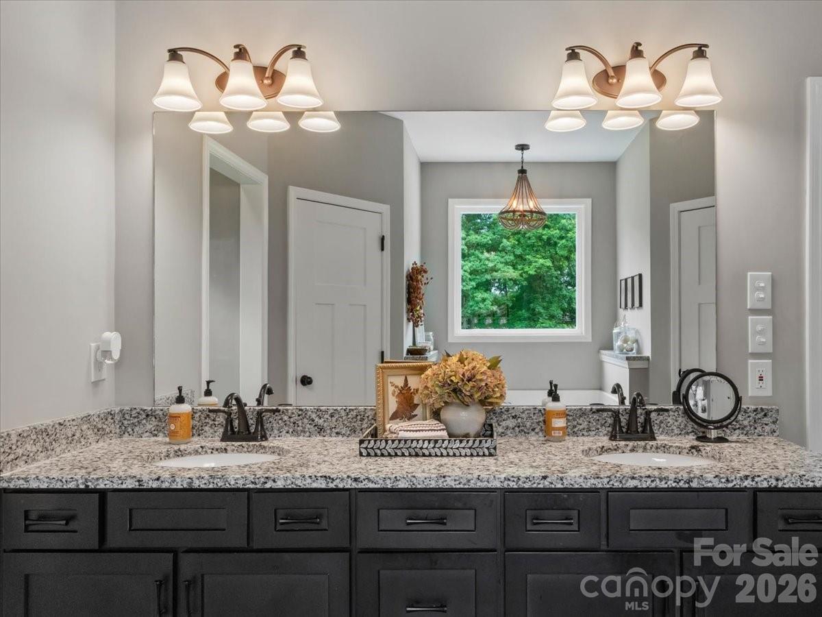 36 Cherry Ridge Lane Weaverville, NC 28787 - Photo 21 of 37 a bathroom with a granite countertop sink and a large mirror
