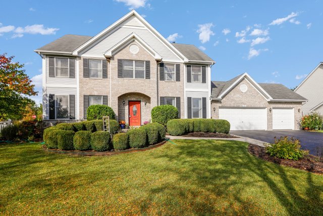 a view of a house with a big yard and potted plants