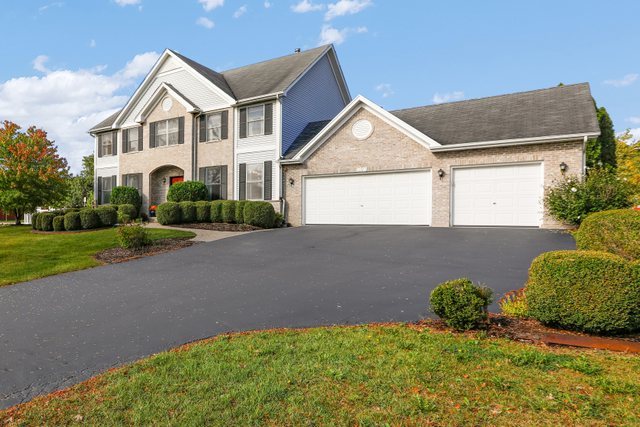 1350 Hunters Ridge West Hoffman Estates, IL 60192 - Photo 2 of 41 a front view of a house with garden