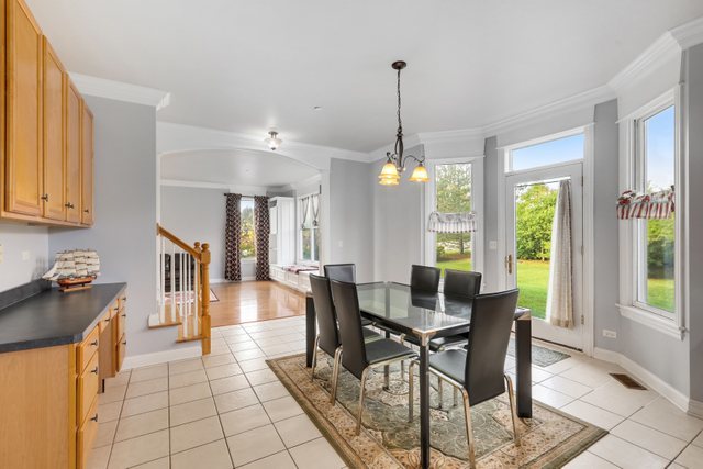 1350 Hunters Ridge West Hoffman Estates, IL 60192 - Photo 13 of 41 a view of a dining room and livingroom with furniture wooden floor a chandelier