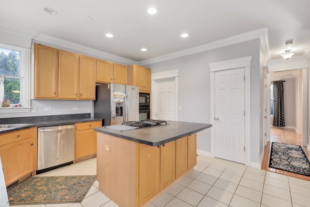 1350 Hunters Ridge West Hoffman Estates, IL 60192 - Photo 15 of 41 a kitchen with stainless steel appliances granite countertop a sink and cabinets