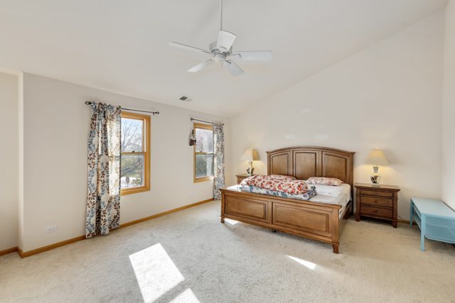 1350 Hunters Ridge West Hoffman Estates, IL 60192 - Photo 20 of 41 a bedroom with a bed and a window