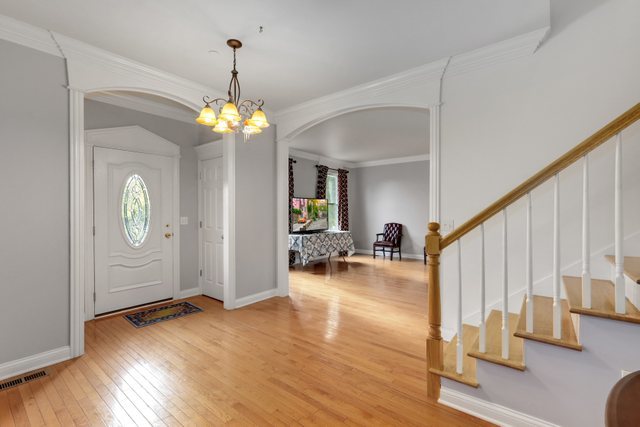 1350 Hunters Ridge West Hoffman Estates, IL 60192 - Photo 3 of 41 a view of a livingroom with wooden floor and stairs