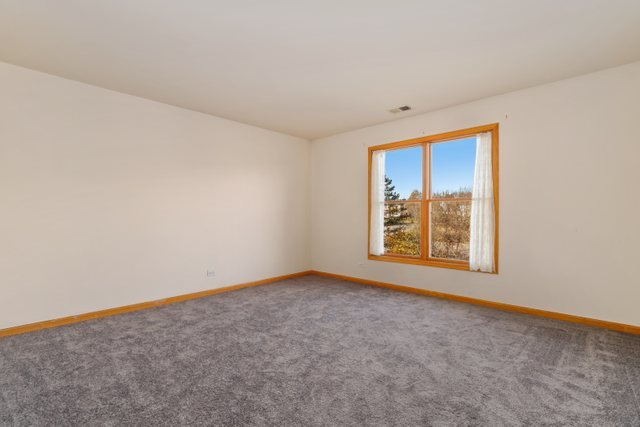 1350 Hunters Ridge West Hoffman Estates, IL 60192 - Photo 25 of 41 an empty room with windows