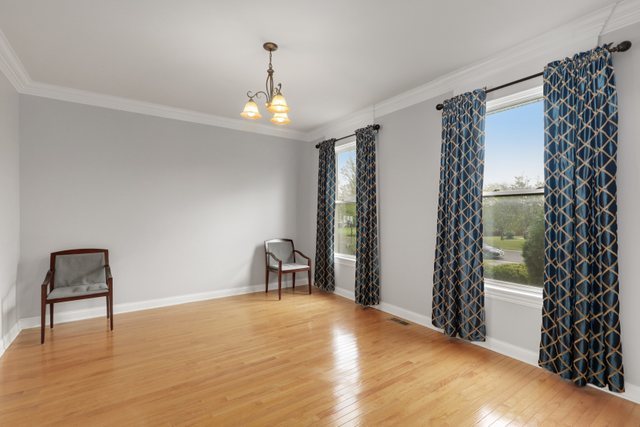 1350 Hunters Ridge West Hoffman Estates, IL 60192 - Photo 5 of 41 a view of an empty room with a window and wooden floor