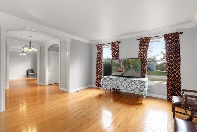 1350 Hunters Ridge West Hoffman Estates, IL 60192 - Photo 7 of 41 a bedroom with a bed and a wooden floor