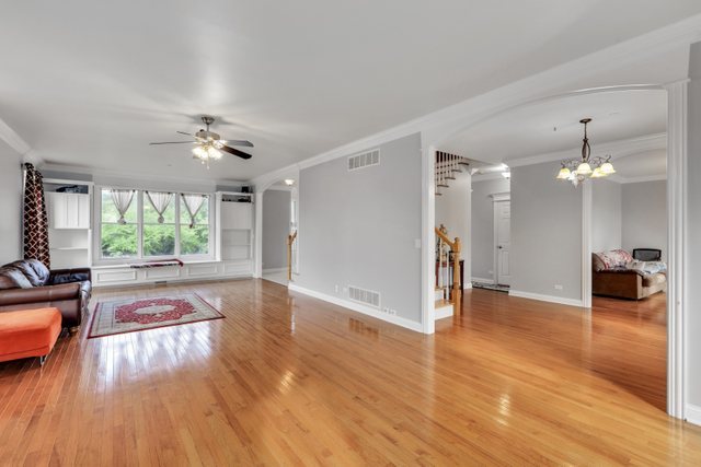 1350 Hunters Ridge West Hoffman Estates, IL 60192 - Photo 10 of 41 a view of a livingroom with furniture wooden floor a flat screen tv