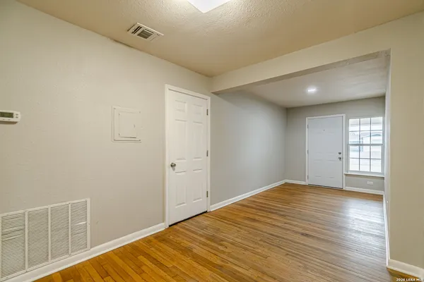 a kitchen with a refrigerator cabinets and wooden floor