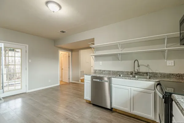 an empty room with wooden floor and a window