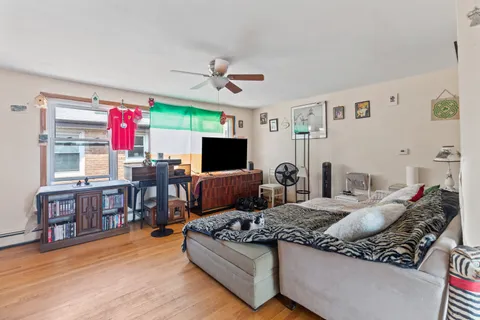 a living room with furniture kitchen view and a flat screen tv
