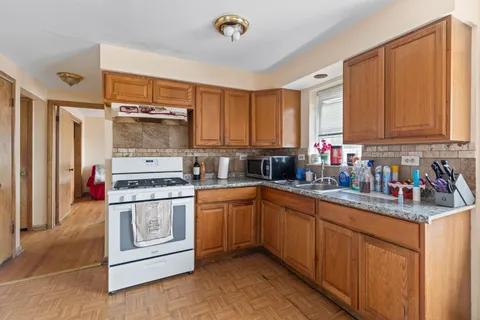 a kitchen with stainless steel appliances granite countertop a stove a sink and a refrigerator