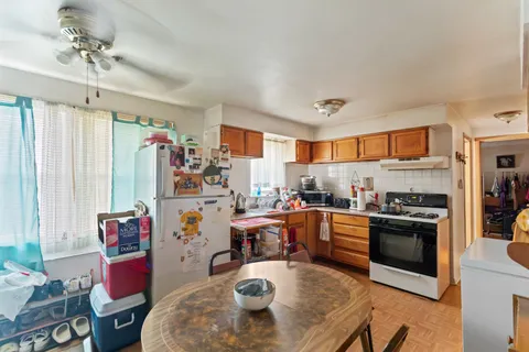 a living room with furniture and a kitchen