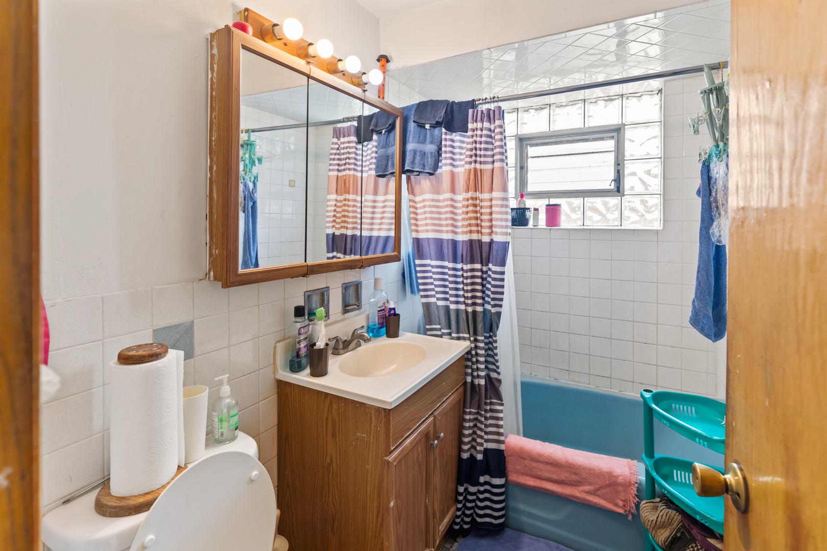 2650 West Touhy Avenue Chicago, IL 60645 - Photo 9 of 17 a bathroom with a sink and a mirror