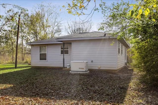 a view of a yard with plants and trees