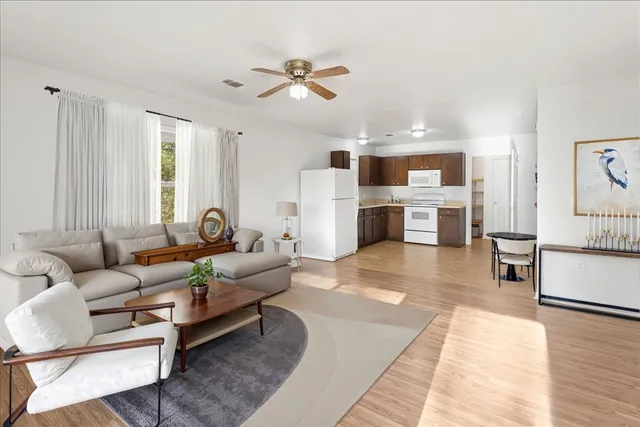 a living room with furniture and kitchen view