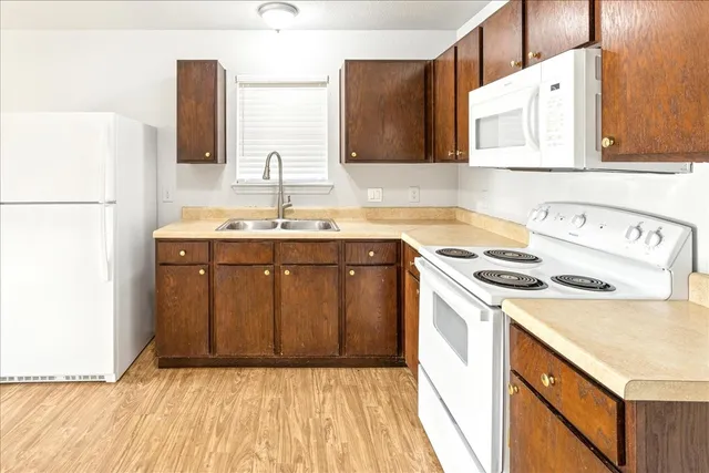 a kitchen with a sink a stove and a refrigerator