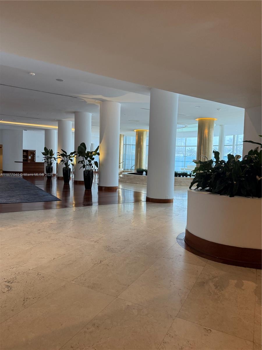 5161 Collins Avenue, Unit 511 Miami Beach, FL 33140 - Photo 14 of 29 a living room with furniture and a chandelier