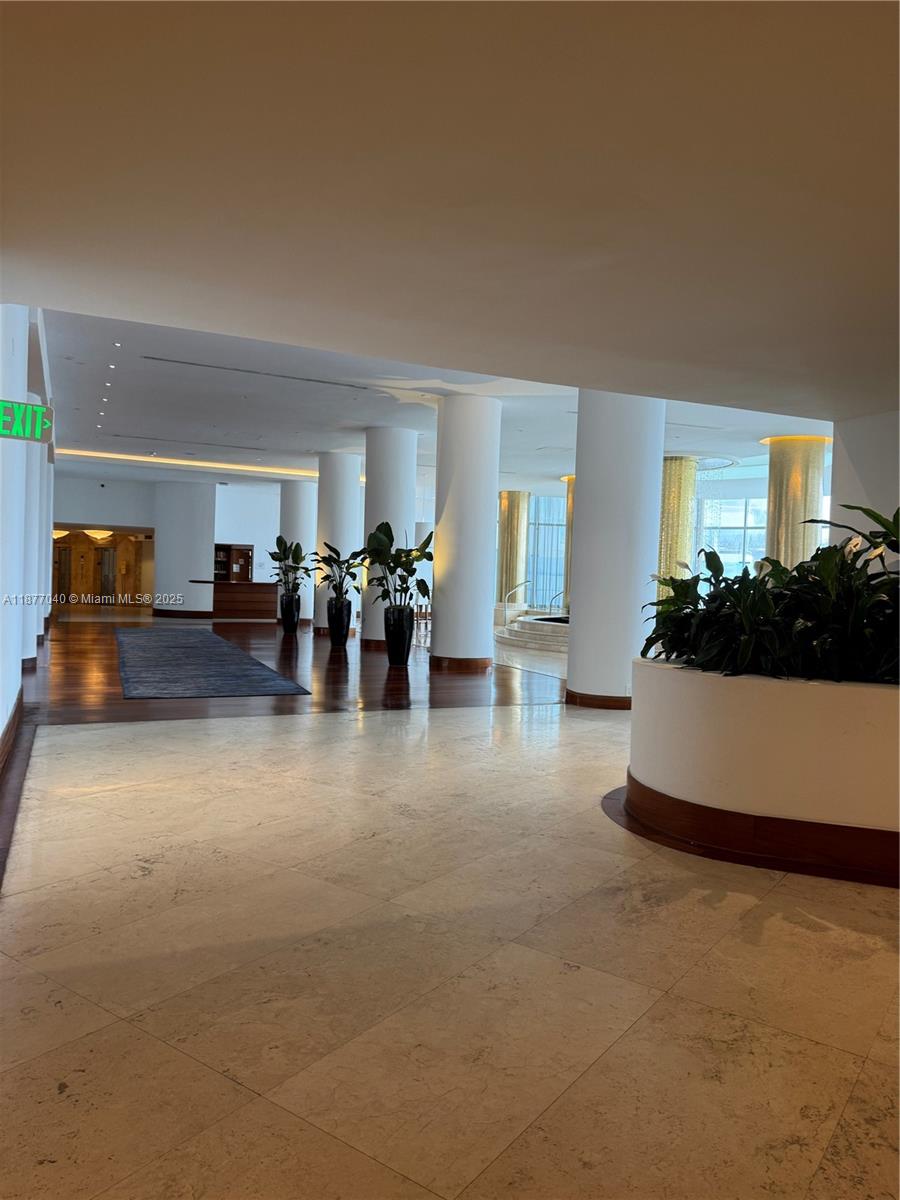 5161 Collins Avenue, Unit 511 Miami Beach, FL 33140 - Photo 15 of 29 a living room with furniture and a chandelier