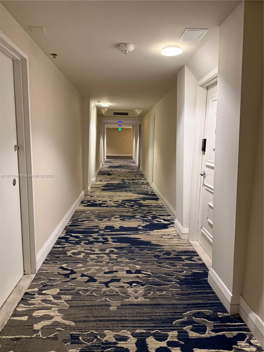 5161 Collins Avenue, Unit 511 Miami Beach, FL 33140 - Photo 18 of 29 a view of a hallway of the house