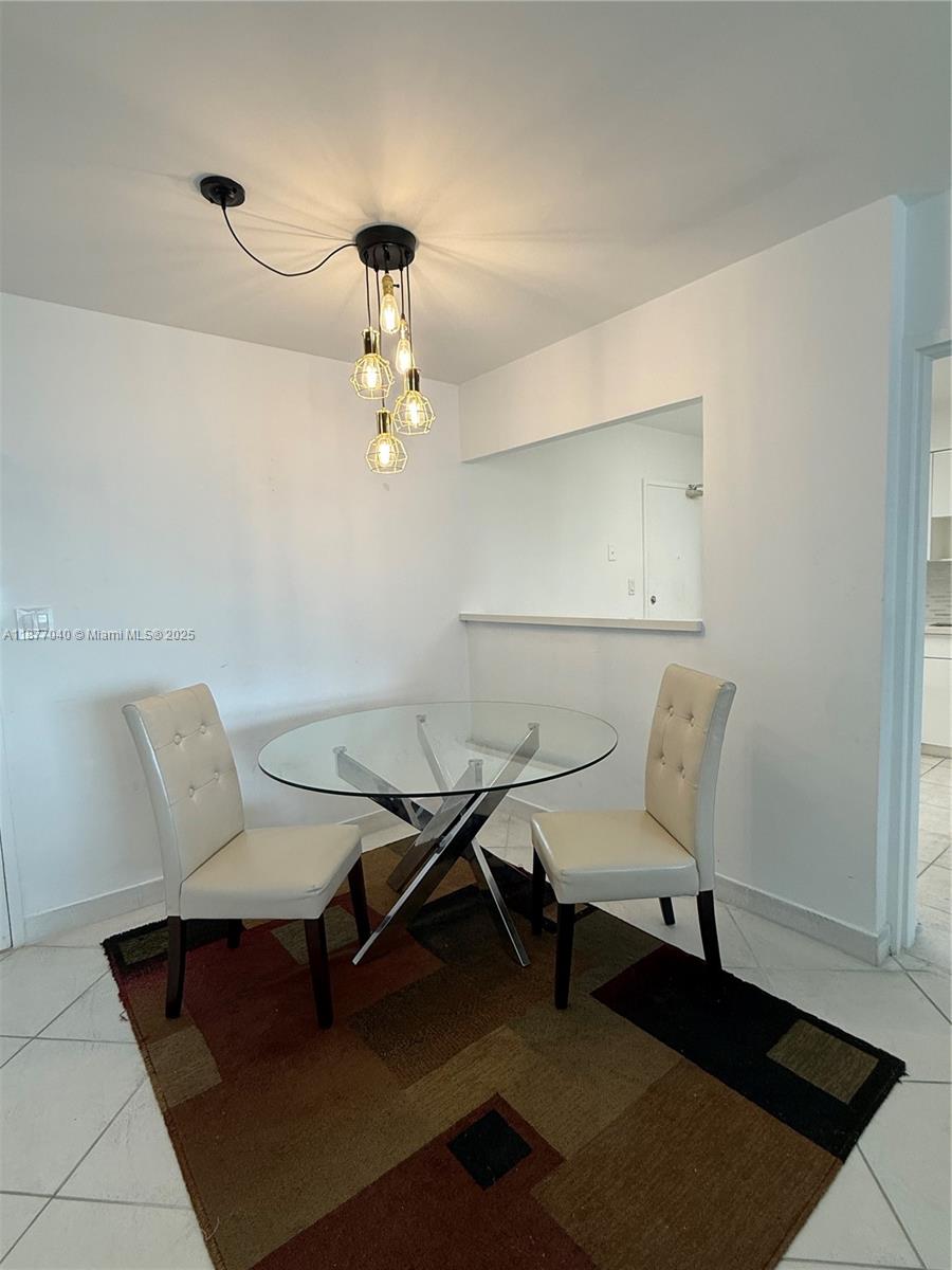 5161 Collins Avenue, Unit 511 Miami Beach, FL 33140 - Photo 3 of 29 a work room with furniture and wooden floor