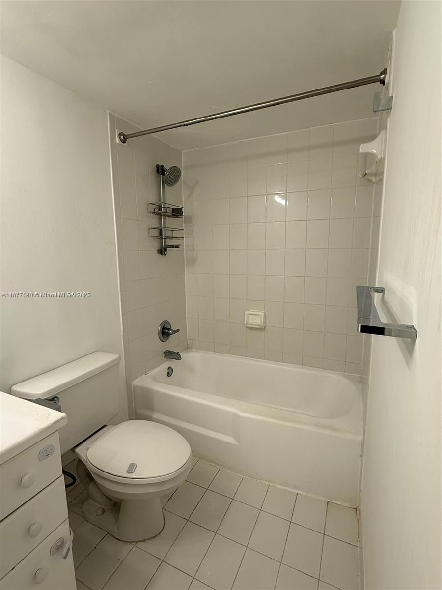 5161 Collins Avenue, Unit 511 Miami Beach, FL 33140 - Photo 5 of 29 a bathroom with a toilet and a bath tub