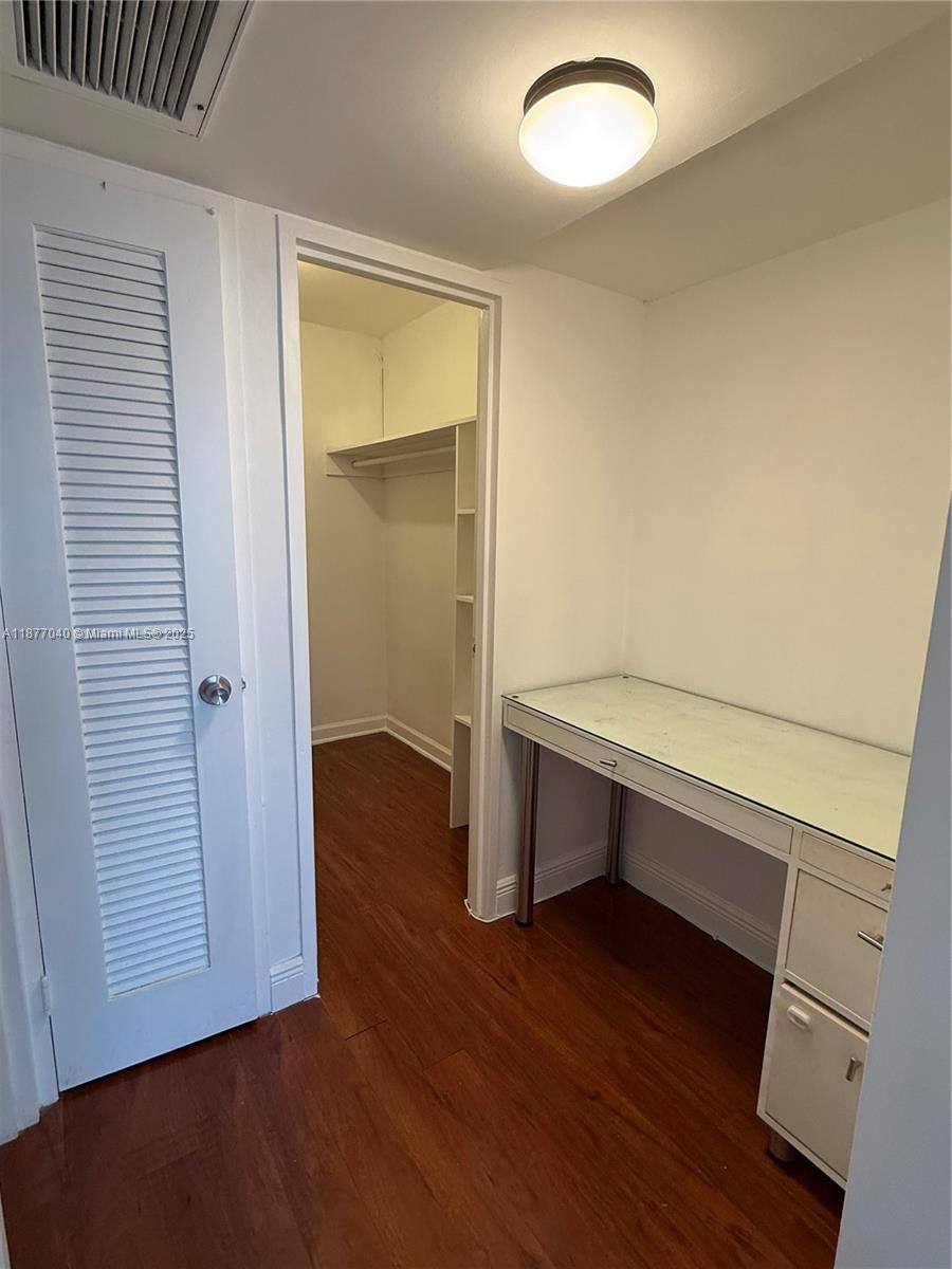 5161 Collins Avenue, Unit 511 Miami Beach, FL 33140 - Photo 6 of 29 an empty room with wooden floor and windows