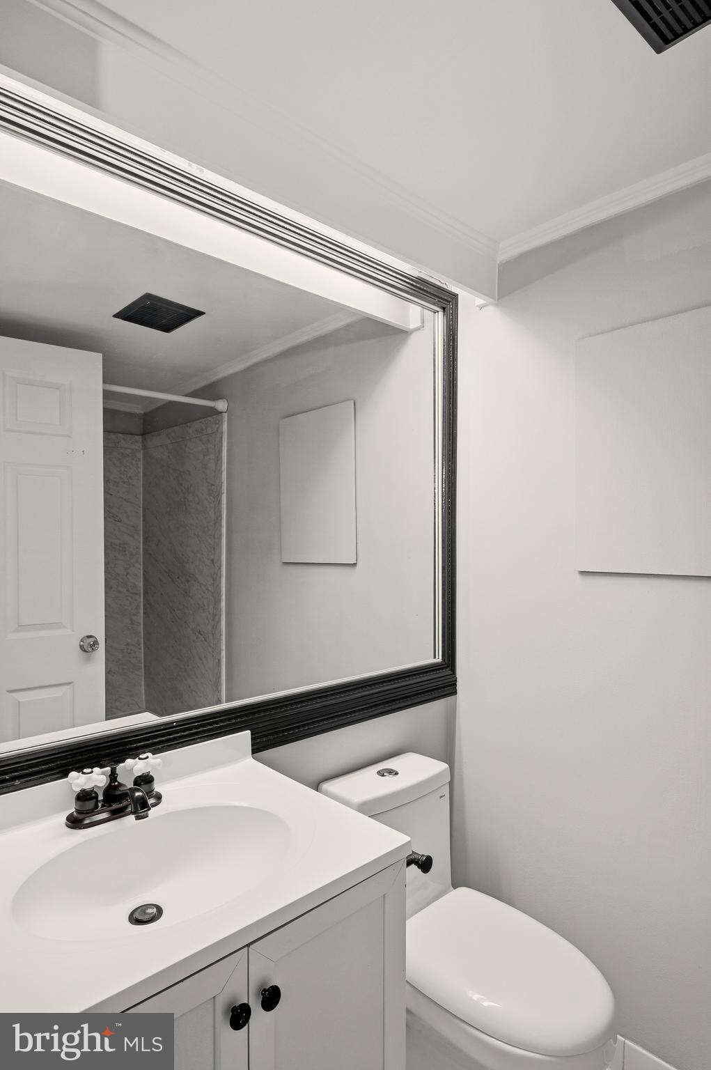 636 Portland Street Baltimore, MD 21230 - Photo 18 of 20 a bathroom with a sink a toilet and mirror