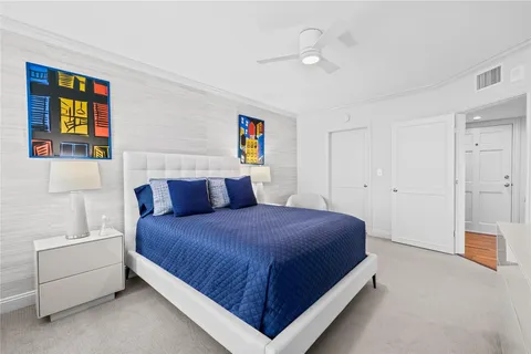 a bedroom with a bed and a couch