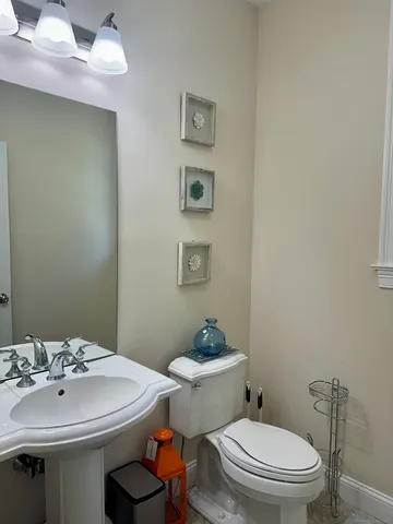 a bathroom with a sink a toilet and mirror