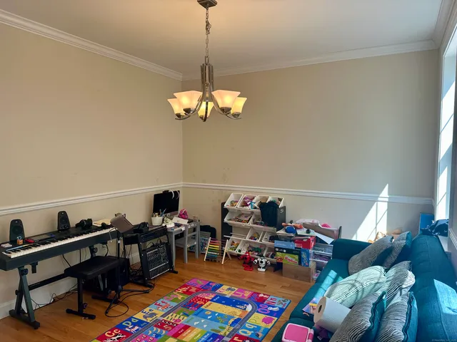 a living room with lots of furniture and a wooden floor