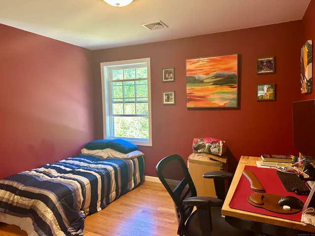 a bedroom with bed and a window