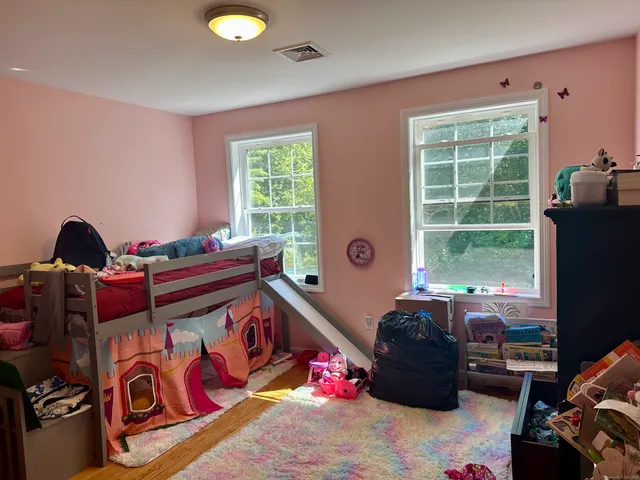 a bedroom with bed and a window