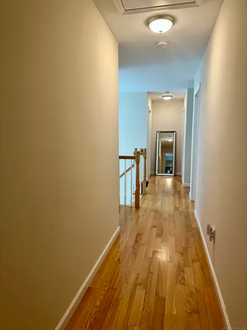 a view of a room with wooden floor and furniture