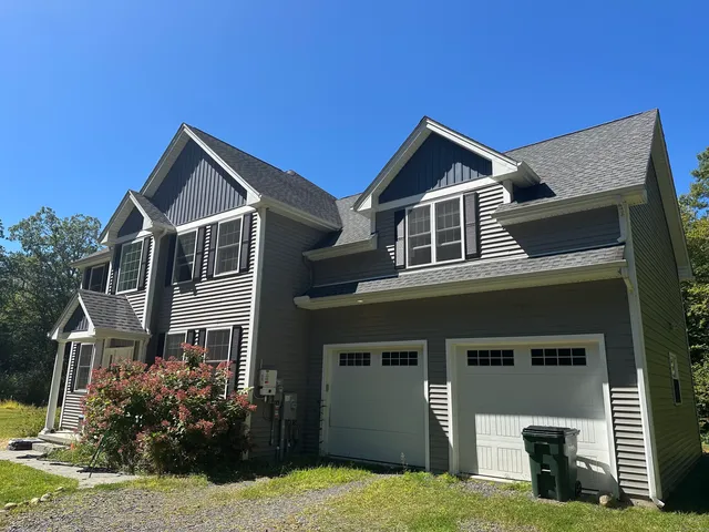 a front view of a house with a yard and garage