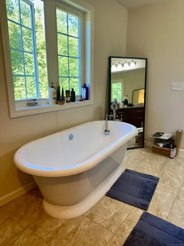 a bathroom with a bathtub and window