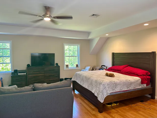 a bedroom with a bed and a flat screen tv