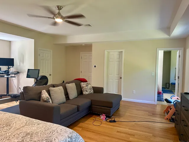 a living room with furniture and a ceiling fan