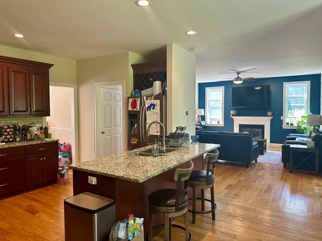 a kitchen with granite countertop a stove and a refrigerator